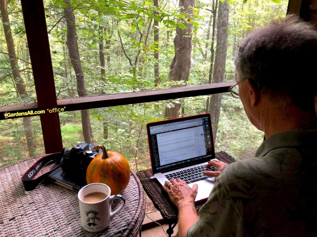 Coleman Alderson working on the GardensAll Newsletter-on the screened porch home office