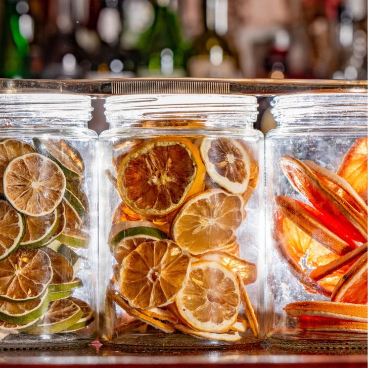 Dehydrated oranges lemons and limes in glass jars