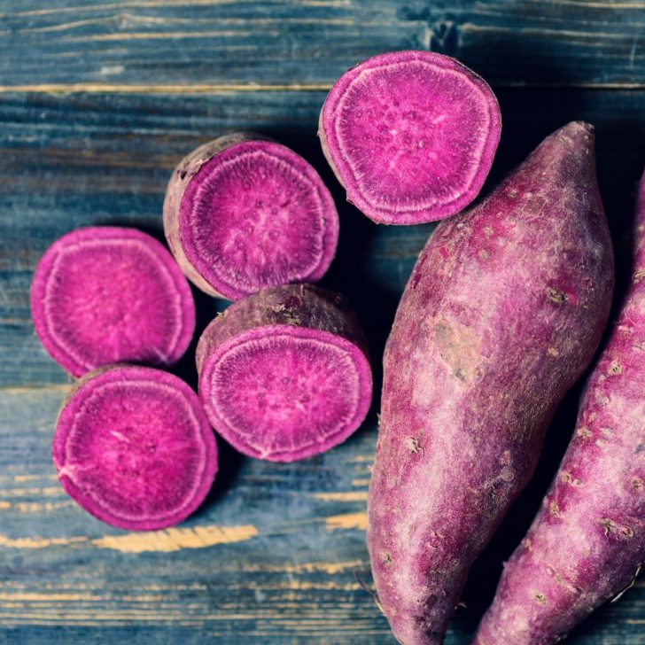 Purple-sweet-potatoes-on-blue-wood-table